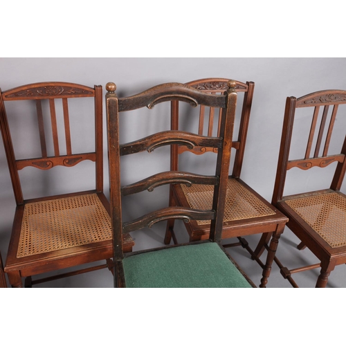 94 - A set of four oak dining chairs with carved top rails, three vertical slats, caned seats, turned leg... 