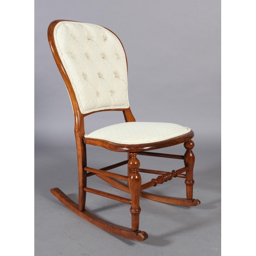 99 - A Victorian walnut stained beech rocking chair, the rounded back with buttoned upholstered panel, st... 