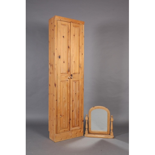 112 - A pine wardrobe enclosed by a pair of fielded panel doors, 204cm high x 56cm wide x 28cm deep togeth... 