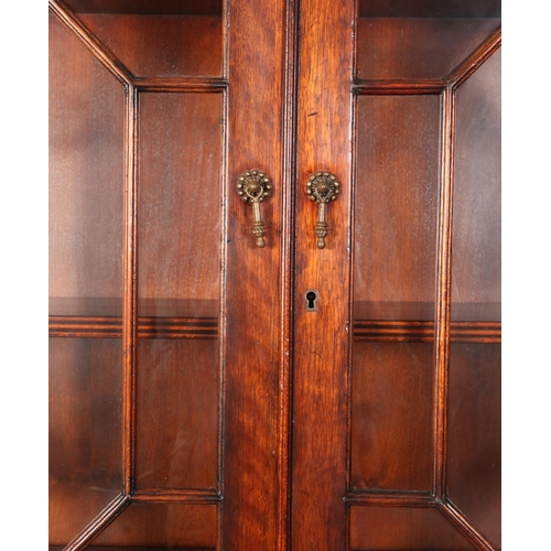 117 - A George III mahogany designed bureau-bookcase crossbanded and boxwood strung, having two astragal g... 