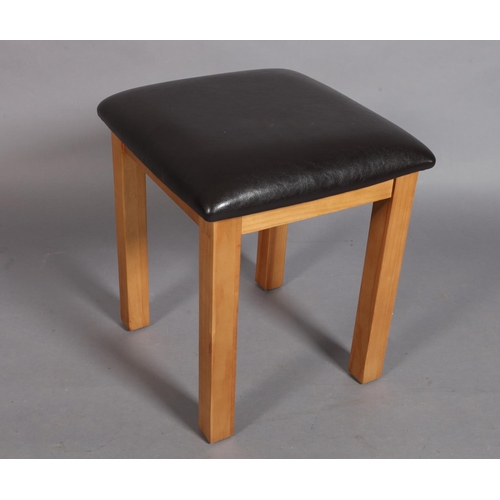 127 - A square footstool with brown simulated leather stuffed over top, 40cm square