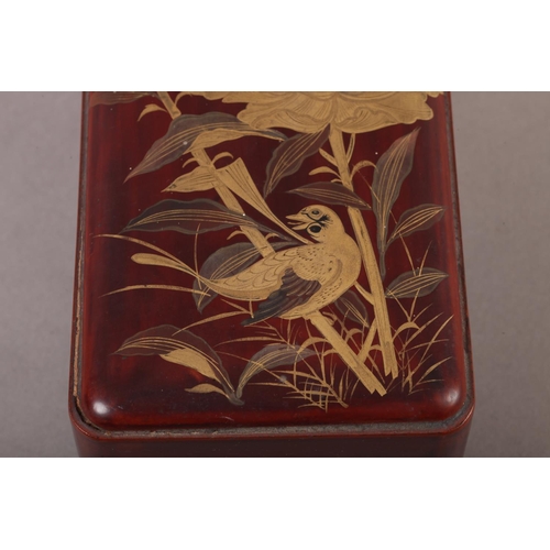 183 - A Japanese red lacquer box and cover of rounded rectangular form, the pull off lid decorated in brow... 