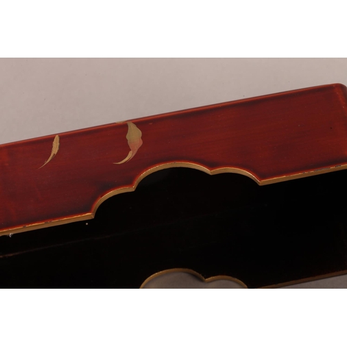 183 - A Japanese red lacquer box and cover of rounded rectangular form, the pull off lid decorated in brow... 