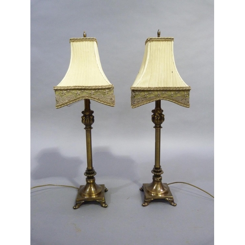 102 - Pair of reproduction brass columnar table lamps on spreading circular bases with square plinths outs... 