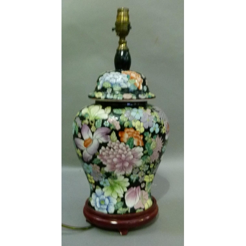 104 - A reproduction Chinese style vase of famille rose on a black ground, 48cm high to the fitting