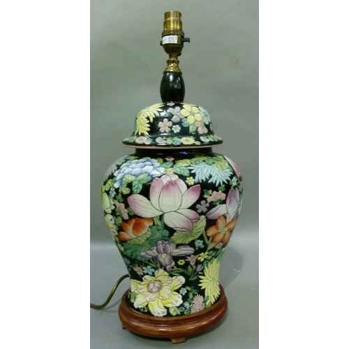 104 - A reproduction Chinese style vase of famille rose on a black ground, 48cm high to the fitting