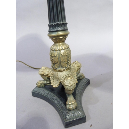 108 - A Regency style metal column table lamp with acanthus wrapped base and three lion paw feet on the in... 