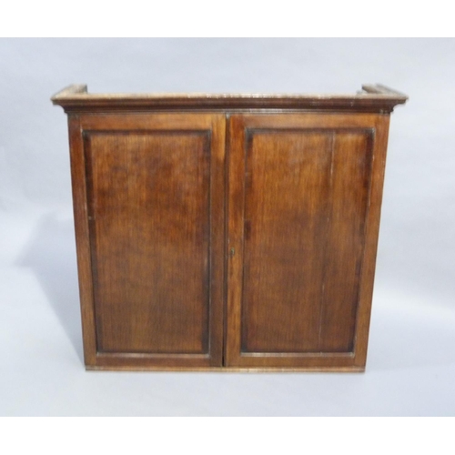 122 - A George III oak cupboard top with cavetto moulded cornice, the pair of doors mahogany crossbanded r... 