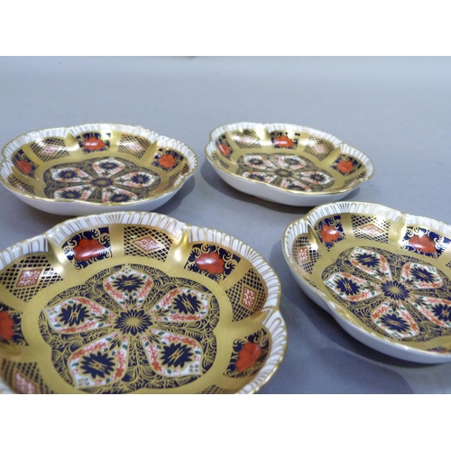 30 - A set of four Royal Crown Derby pattern 1128 shaped circular pin trays, 11.5cm wide