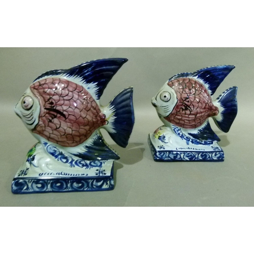 35 - A pair of Portuguese Alcobaca pottery fish ornaments decorated with black scaled pink bodies, blue t... 