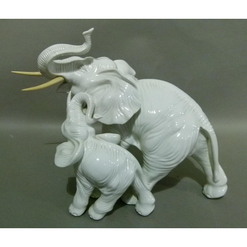 37 - A white pottery figure of an elephant with ivorine tusks, 35cm high