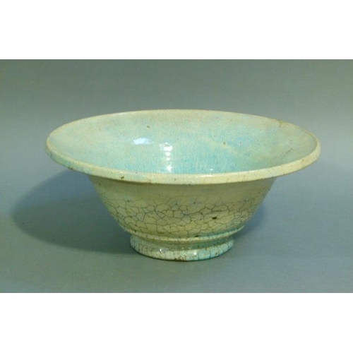 38 - A circular bowl, the raku glaze tinted from duck egg blue to turquoise, on circular foot, 32cm diame... 