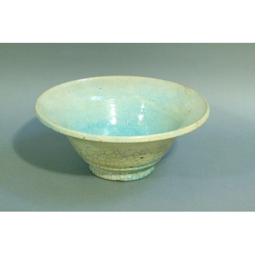 38 - A circular bowl, the raku glaze tinted from duck egg blue to turquoise, on circular foot, 32cm diame... 