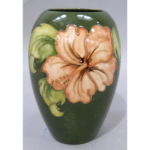 7 - A Moorcroft pottery vase of ovoid shape, tube lined and glazed in coral and green wiith hibiscus, im... 