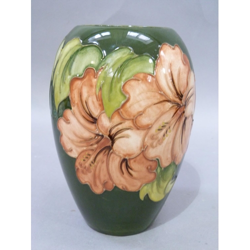 7 - A Moorcroft pottery vase of ovoid shape, tube lined and glazed in coral and green wiith hibiscus, im... 