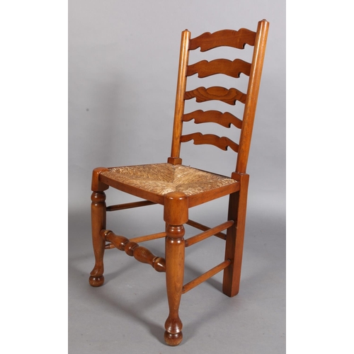 95 - A reproduction elm ladder back dining chair with rush seat