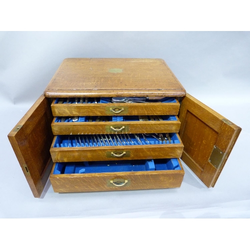 188 - An Edwardian oak chest canteen with brass inset side carrying handles, two indented panel doors, the... 