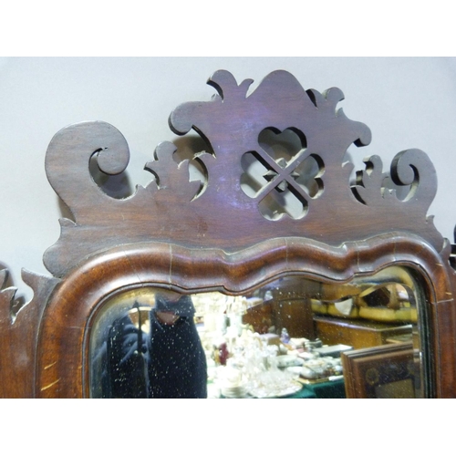 215 - A late 19th/ early 20th century rectangular mirror of 18th century design having a fret cut pediment... 