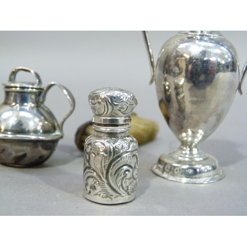 227 - Four items of miniature silver: urn shaped pepperette, Birmingham 1893, Jersey jug 1910, scent bottl... 