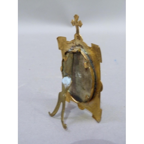 242 - A head and shoulders portrait of Christ, printed on ceramic plaque held within a brass frame with cr... 