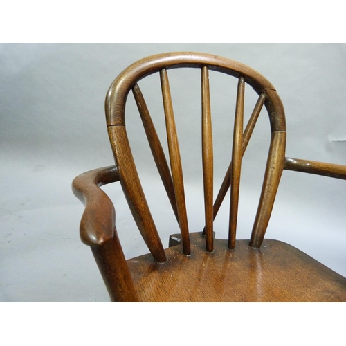 246 - A child's oak rail back chair, serpentine arms, on turned legs with 'H' stretcher, 63cm H at back