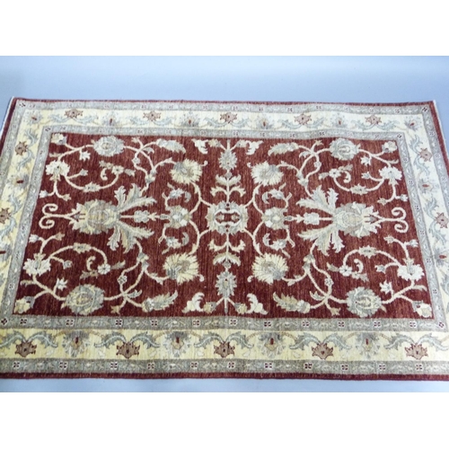 268 - A Ziegler design rug, made in Pakistan, measuring 1.87m x1.22m in crimson, ivory and camel