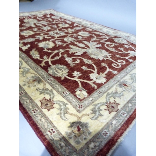 268 - A Ziegler design rug, made in Pakistan, measuring 1.87m x1.22m in crimson, ivory and camel