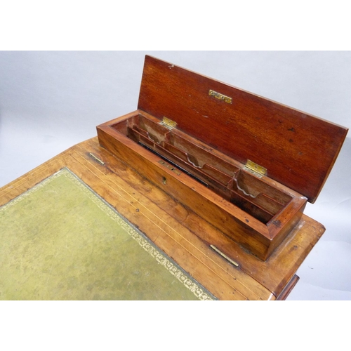 279 - A Victorian walnut Davenport inlaid in box and ebony with foliate scrolls having a raised stationery... 