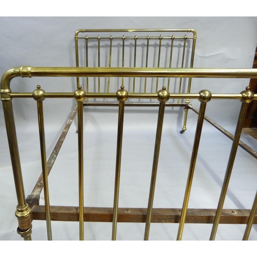 284 - A Victorian brass rail end double bed stead, complete with irons