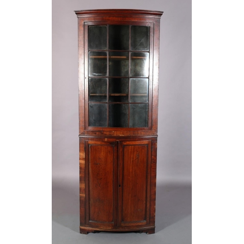 301 - A 19th century mahogany bow front standing corner cupboard, having a moulded cornice above a twelve ... 