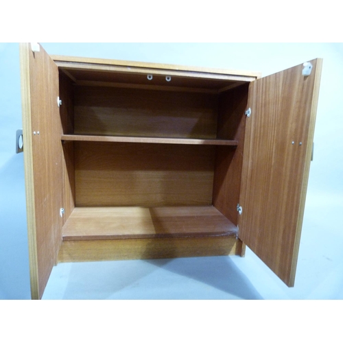 308 - A teak two door cupboard with metal handles, circa 1970's, 76 cm W x 74cm H