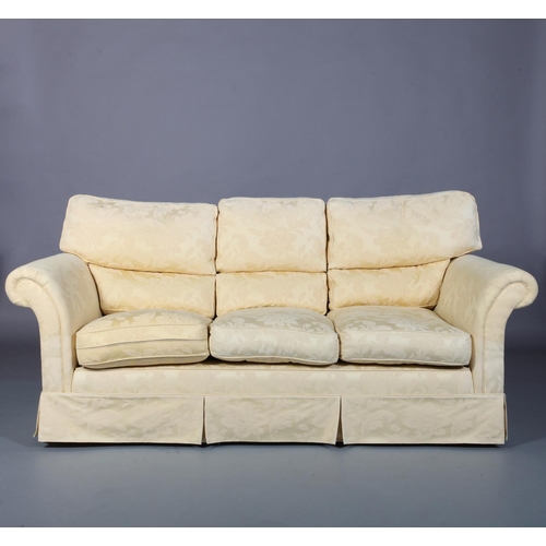 100 - A yellow cotton upholstered three seater sofa