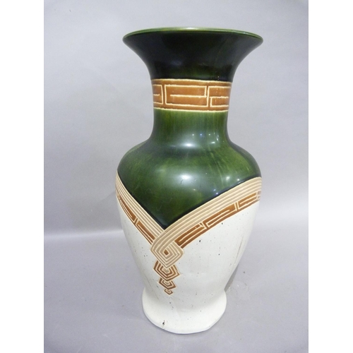 115 - A large pottery baluster vase decorated in olive green, cream and with geometric motifs in brown, 52... 