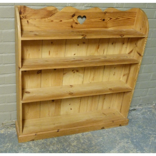 144 - A pine book shelf with shaped top centred on a pierced heart shaped motif, four shelves, 102cm wide ... 