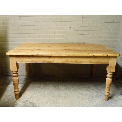 150 - A pine breakfast table, the rounded rectangular top above a frieze fitted single drawer and turned t... 