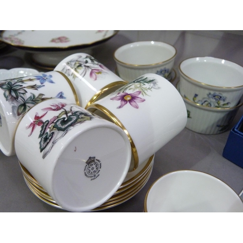 174 - A set of five Royal Worcester coffee cans and saucers each painted with a different flower, a Royal ... 