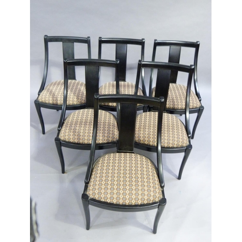 332 - A set of six ebonised spoon back dining chairs with broad splat to the back, upholstered seat and on... 