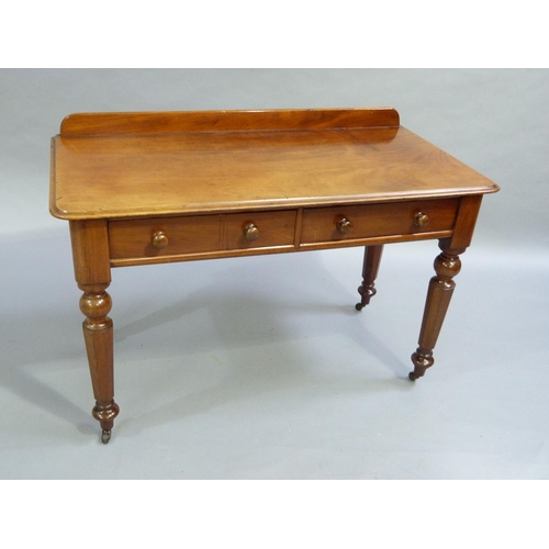 333 - A C19th mahogany side table having a short raised back, moulded edge to the surface with two drawers... 