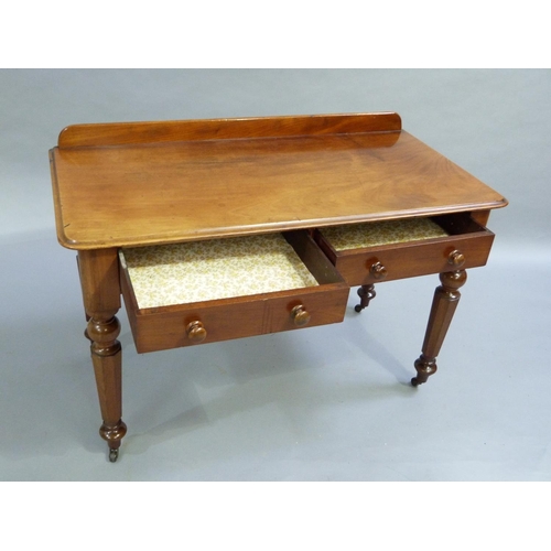 333 - A C19th mahogany side table having a short raised back, moulded edge to the surface with two drawers... 