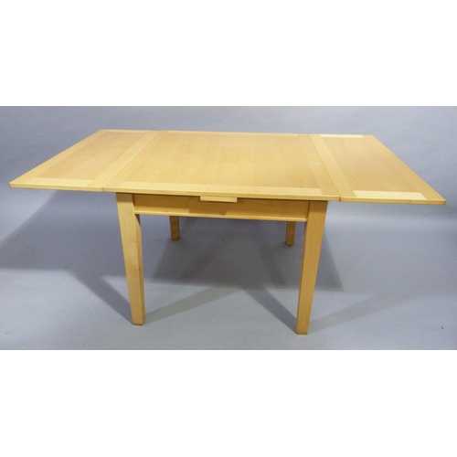 335 - A blonde beech veneer draw leaf dining table on square legs, extended 167 x97cm