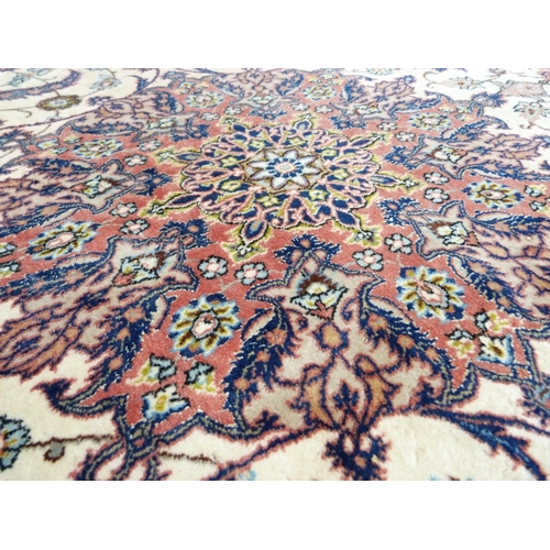 339 - A Persian style  carpet, the ivory field having a central medallion in deep pink within a surround o... 