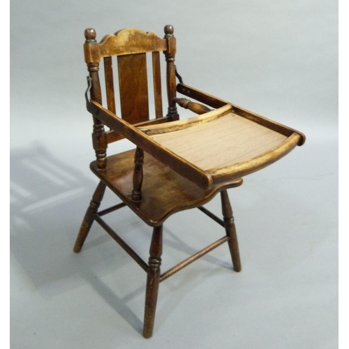 340 - An early C20th child's high chair with fold over table surface