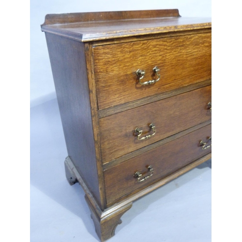 342 - An oak chest of three drawers with gilt metal swing handles and on shaped bracket feet, 81 W x 45 D ... 