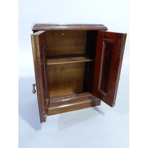 349 - A table top cabinet having two field panel doors and conforming side panels on plinth base, the inte... 