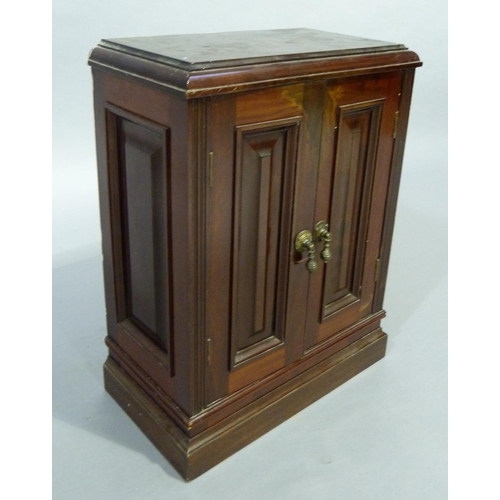 349 - A table top cabinet having two field panel doors and conforming side panels on plinth base, the inte... 