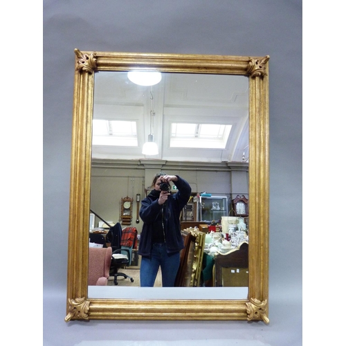 356 - A modern gilt framed wall mirror, the moulded frame with applied leaf corners, rectangular, 123x92 c... 