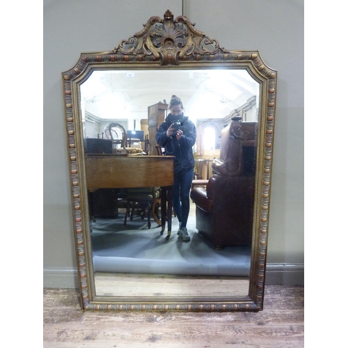 357 - A gilt framed wall mirror of C19th design having an elaborate foliate pierced cresting, the rectangu... 