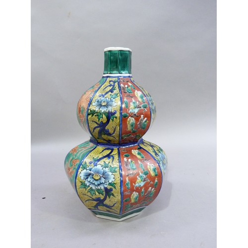 20 - A 20th century Japanese double gourd vase of octagonal outline painted with alternating panels of fi... 