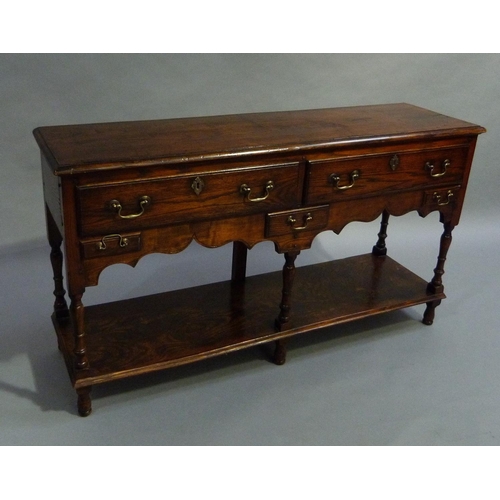 274 - A reproduction oak dresser base, having two drawers across and three small drawers to the ogee arche... 