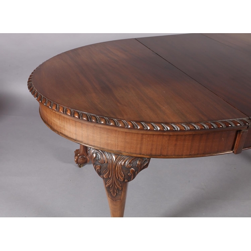 261 - A reproduction extending dining table in George III style, the oval top with gadroon lip above a dee... 